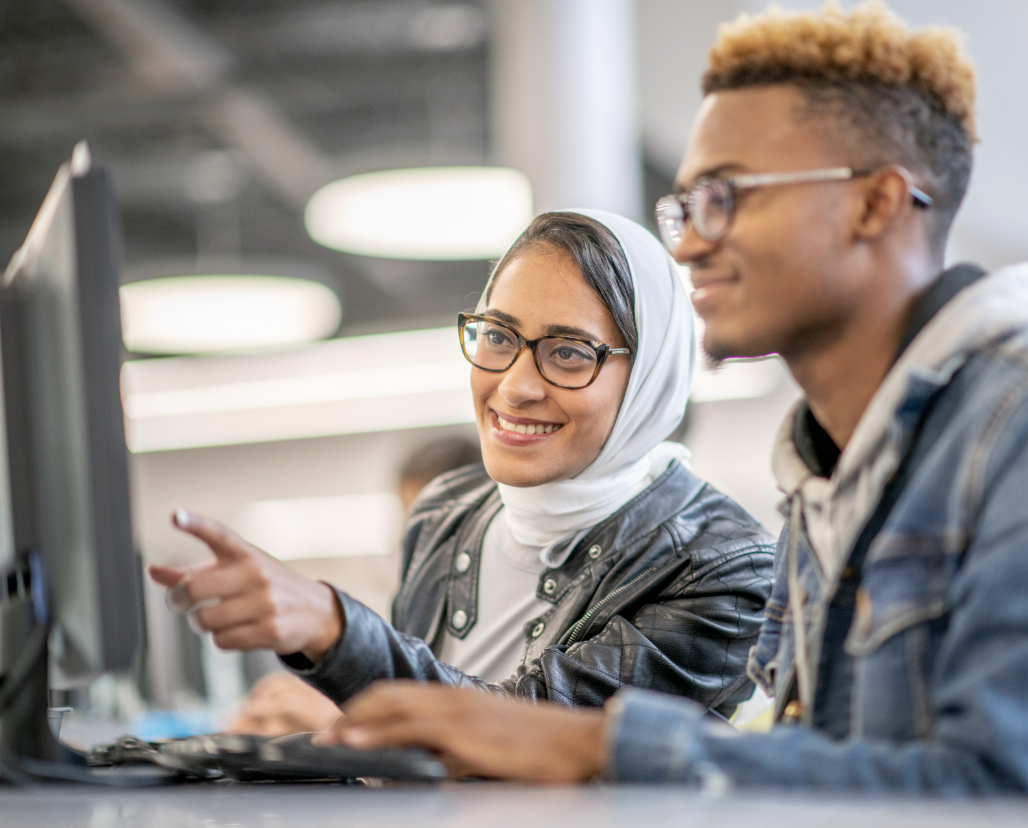 Two students looking at a computer screen